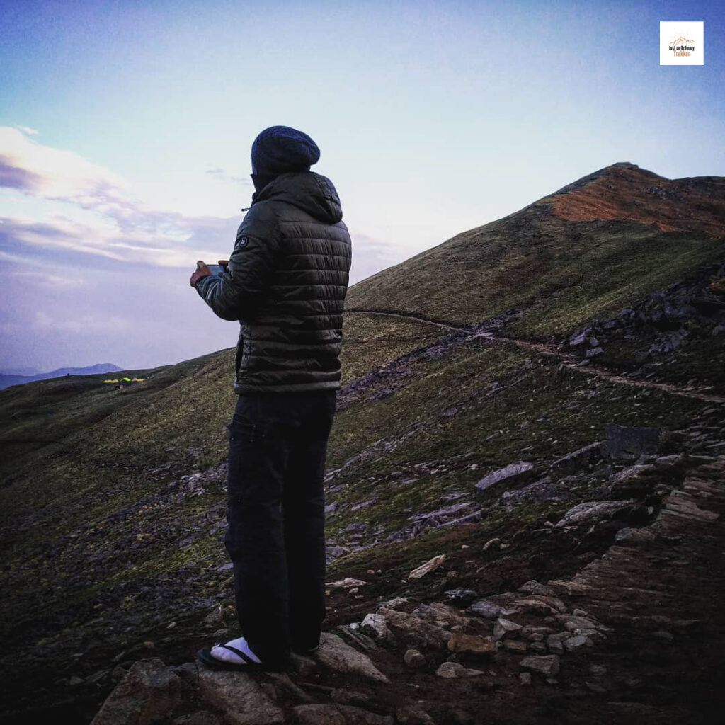 enjoying the view with a warm cup of tea after clouds almost drenched us at Pathar Nachuni during Roopkund Trek