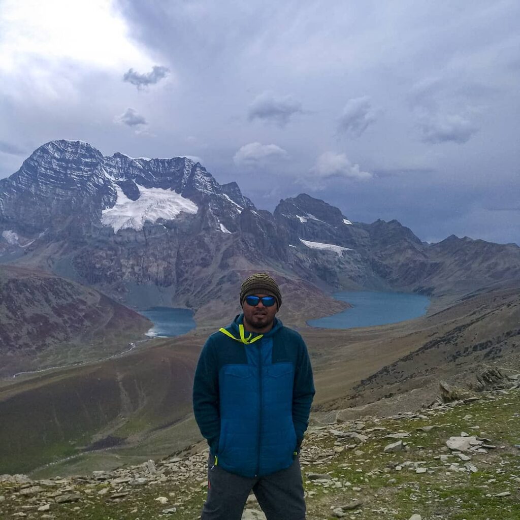 Trekker standing between Gangabal and Nundkol Lakes at Zajibal Pass during Kashmir Great lakes Trek