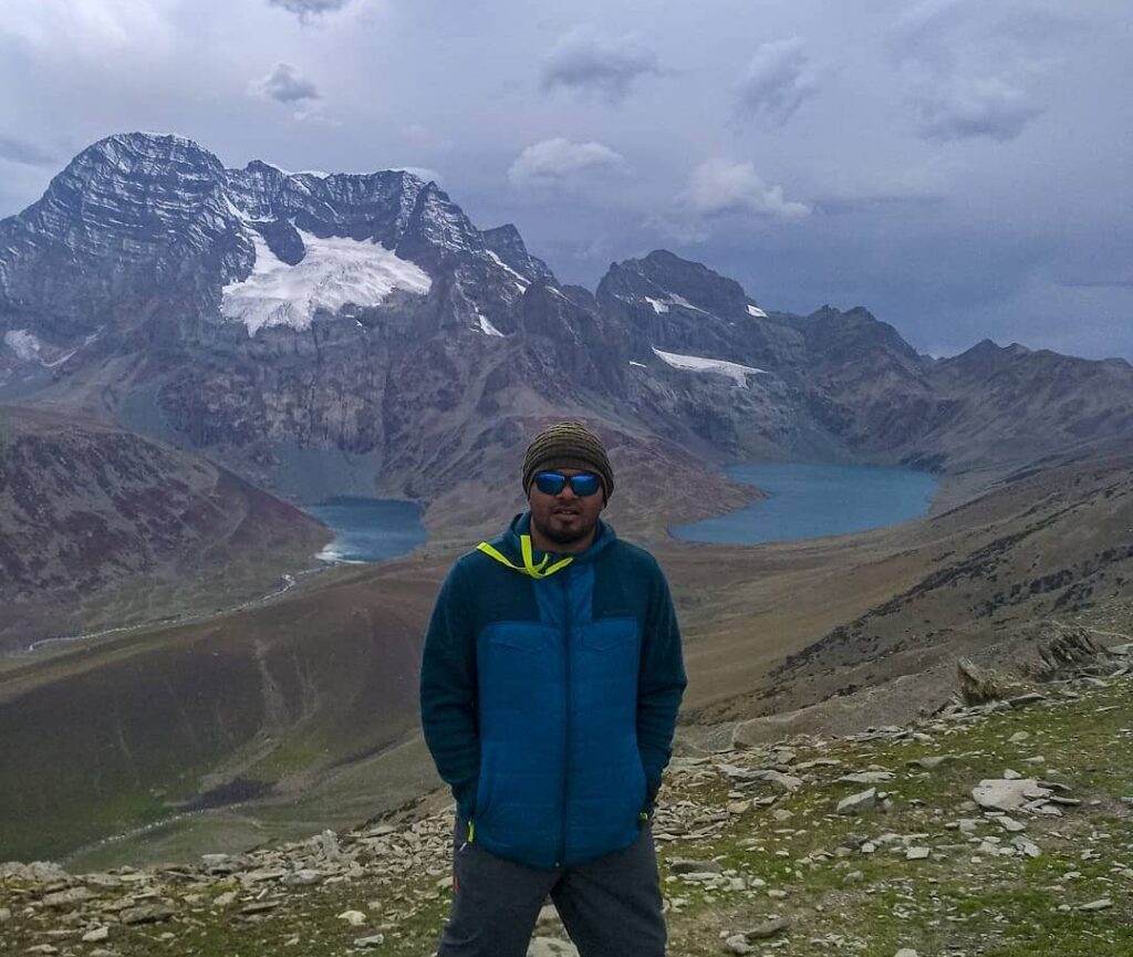Trekker standing between Gangabal and Nundkol Lakes at Zajibal Pass during Kashmir Great lakes Trek