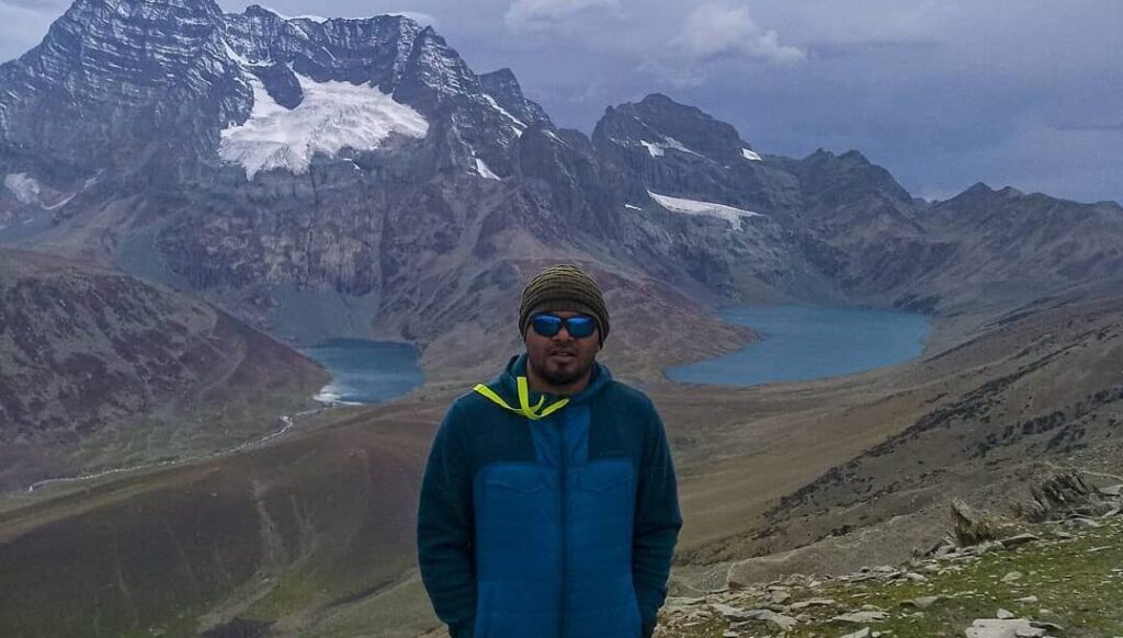 Trekker standing between Gangabal and Nundkol Lakes at Zajibal Pass during Kashmir Great lakes Trek